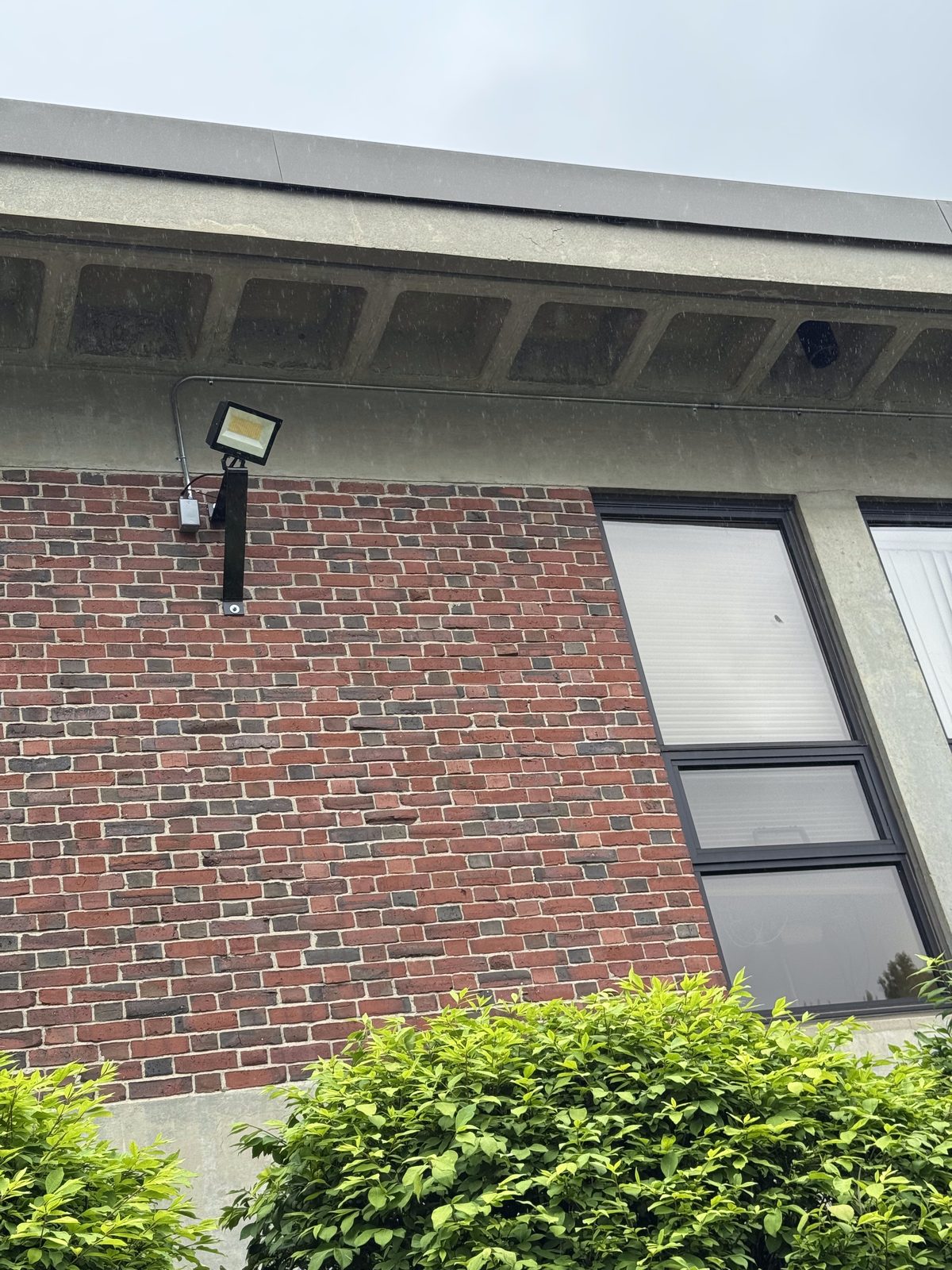 Commercial exterior flood light installation on brick building by Sonny Torres Electrician